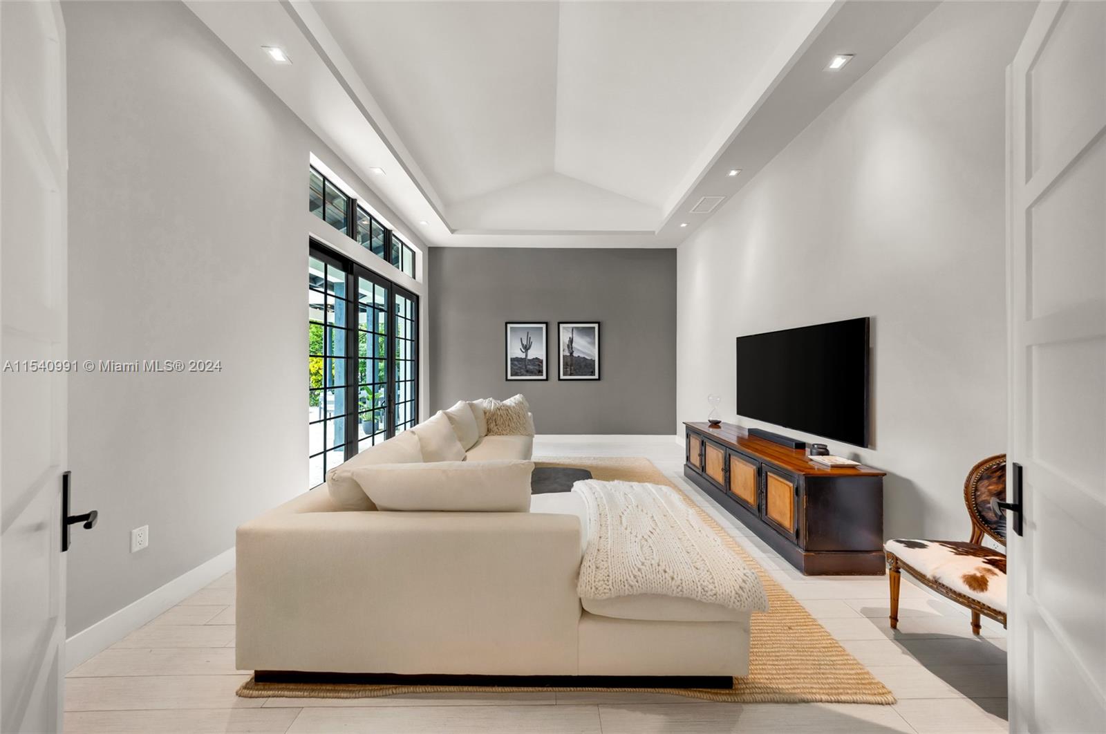 590 Northeast 59th Street Miami, FL 33137 - Photo 11 of 32 a living room with furniture and a flat screen tv