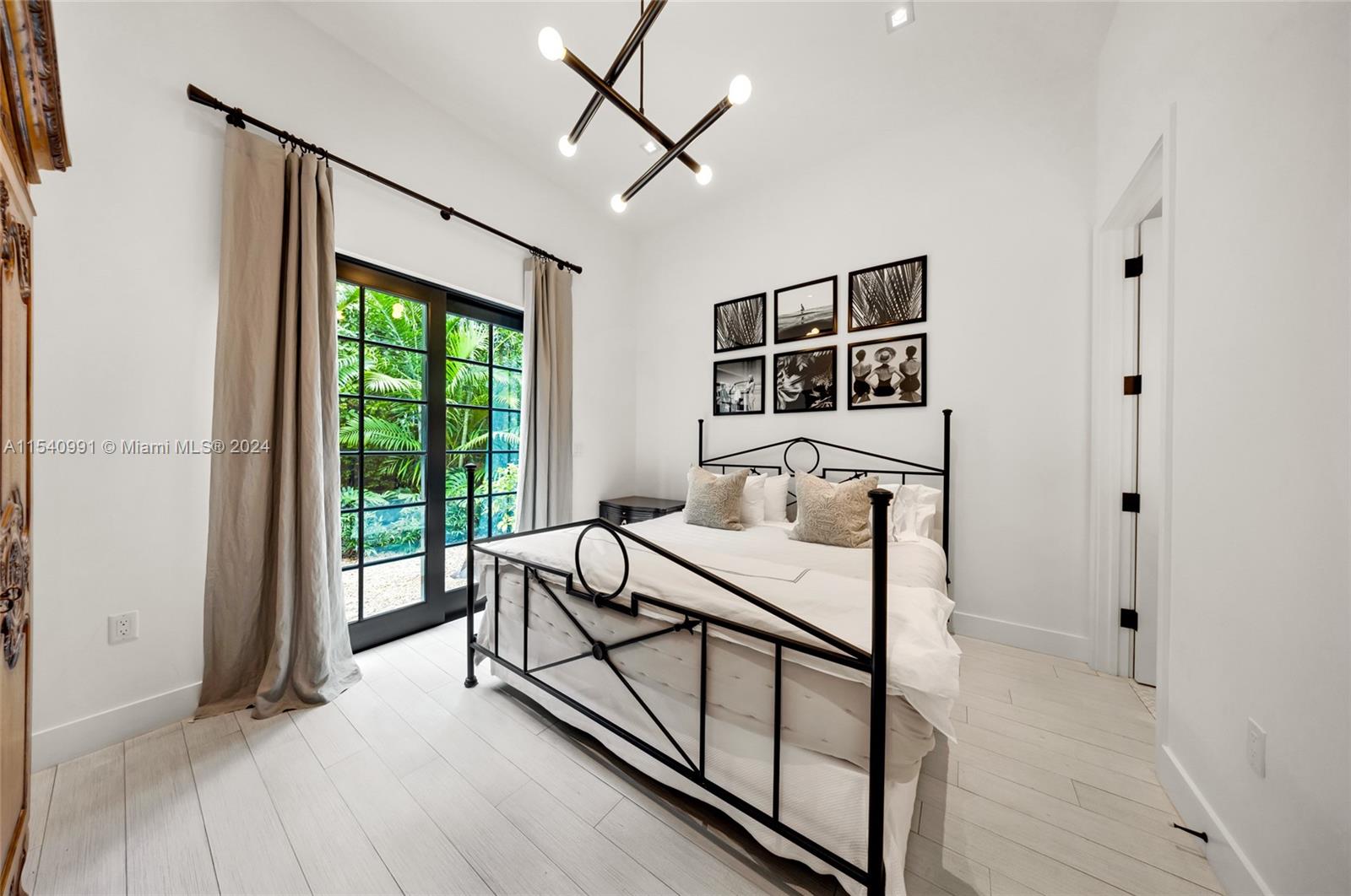 590 Northeast 59th Street Miami, FL 33137 - Photo 12 of 32 a bedroom with furniture and a window