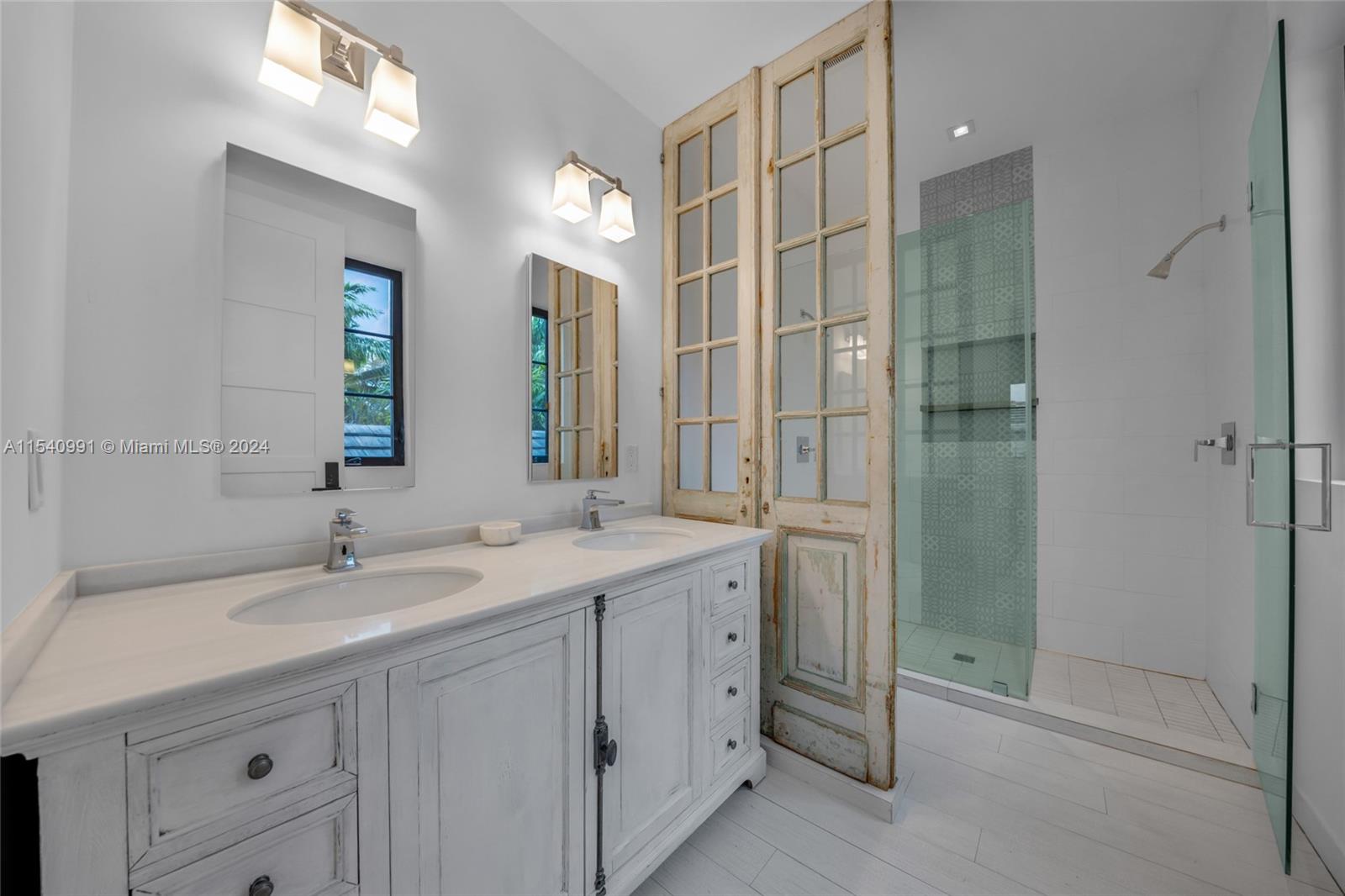 590 Northeast 59th Street Miami, FL 33137 - Photo 14 of 32 a bathroom with a shower sink and mirror