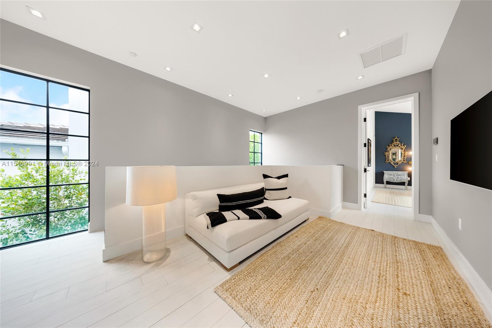 590 Northeast 59th Street Miami, FL 33137 - Photo 16 of 32 a bedroom with a bed and a large window
