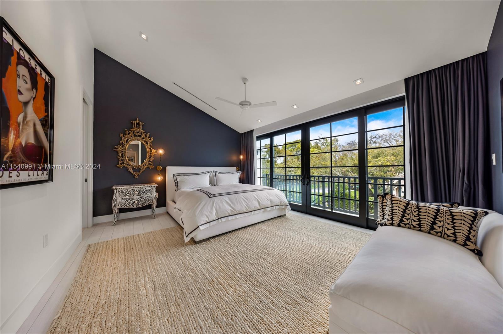 590 Northeast 59th Street Miami, FL 33137 - Photo 17 of 32 a spacious bedroom with a large bed and a large window