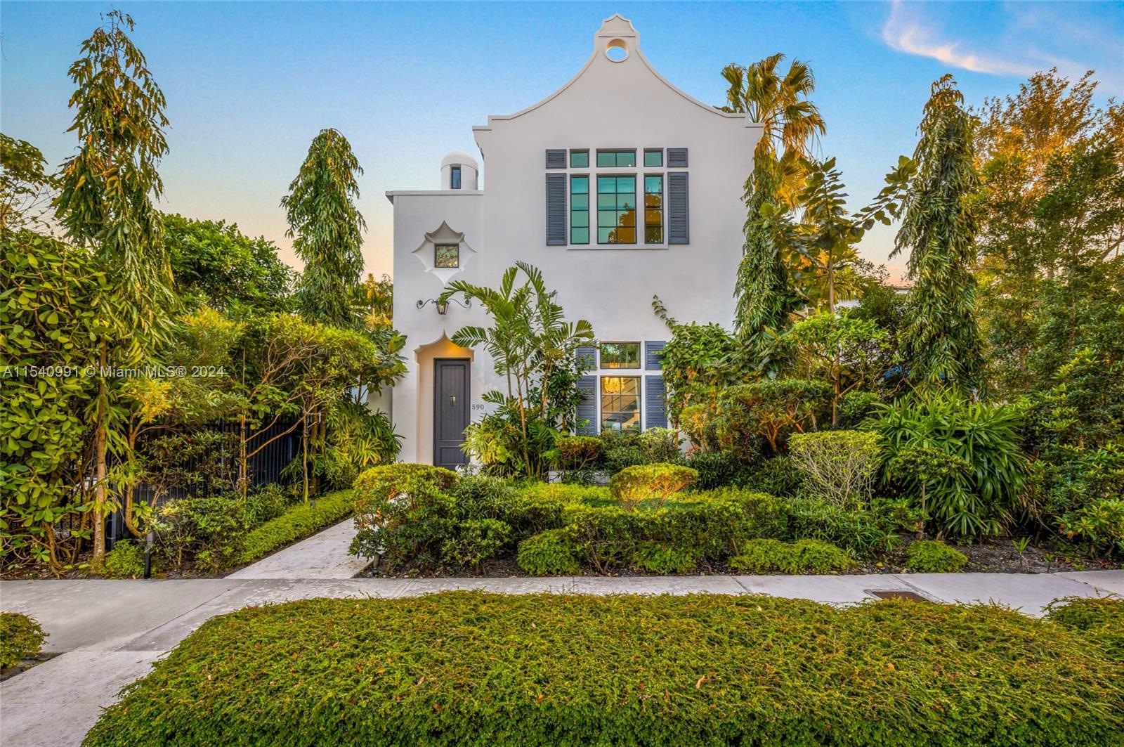 590 Northeast 59th Street Miami, FL 33137 - Photo 2 of 32 a front view of a house with a yard