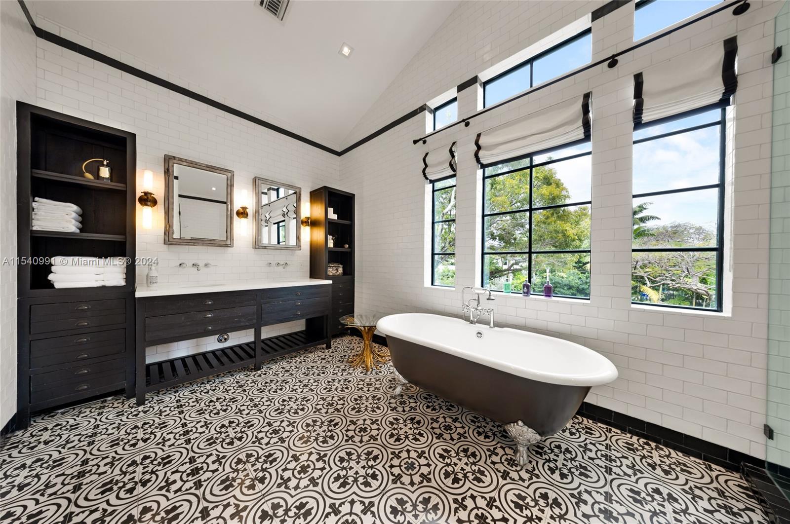 590 Northeast 59th Street Miami, FL 33137 - Photo 21 of 32 a spacious bathroom with a bathtub shower sink and mirror