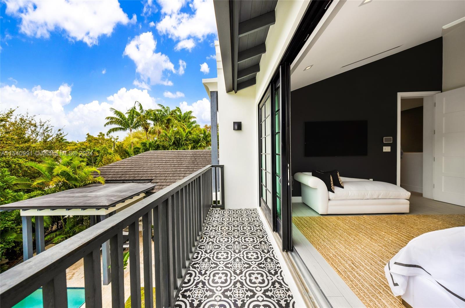 590 Northeast 59th Street Miami, FL 33137 - Photo 22 of 32 a balcony view with a large window and wooden floor
