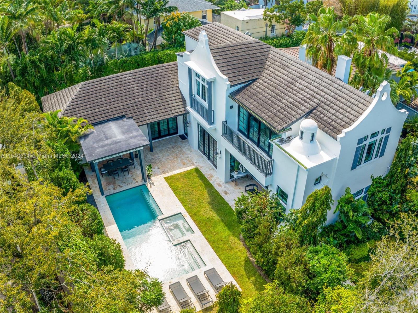 590 Northeast 59th Street Miami, FL 33137 - Photo 3 of 32 aerial view of a house with a yard table and chairs