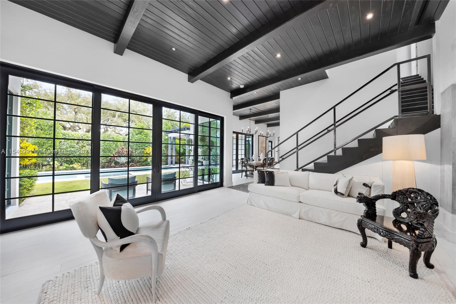 590 Northeast 59th Street Miami, FL 33137 - Photo 6 of 32 a living room with furniture and a floor to ceiling window