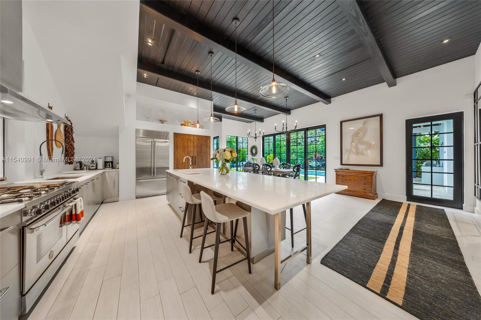 590 Northeast 59th Street Miami, FL 33137 - Photo 10 of 32 a kitchen with stainless steel appliances granite countertop lots of counter top space a stove and a wooden floors