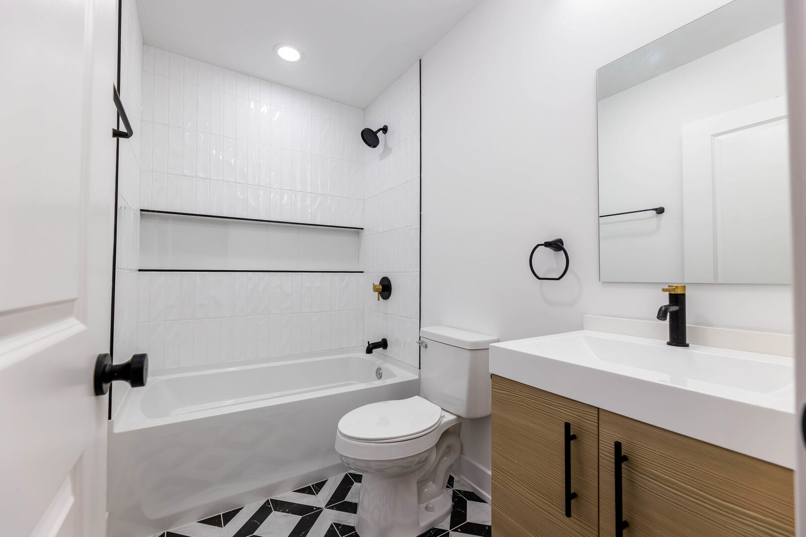 239 West 74th Street, Unit 2 Chicago, IL 60621 - Photo 6 of 9 a bathroom with a sink toilet tub and shower