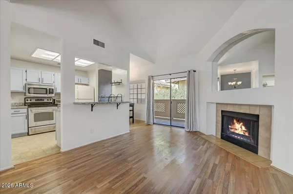 a view of kitchen with wooden floor electronic appliances and window