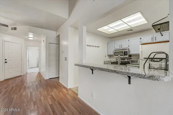a kitchen with stainless steel appliances granite countertop a refrigerator and a sink
