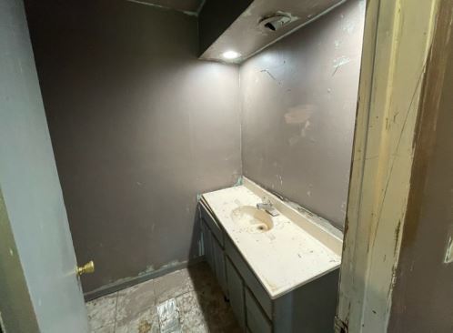 19W719 West Holtz Avenue Addison, IL 60101 - Photo 11 of 11 a bathroom with a granite countertop sink and vanity