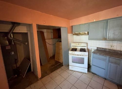 19W719 West Holtz Avenue Addison, IL 60101 - Photo 4 of 11 a kitchen with a refrigerator and cabinets