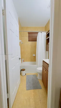 a bathroom with a granite countertop shower a sink and a bathtub