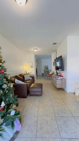 a living room with furniture and flowers