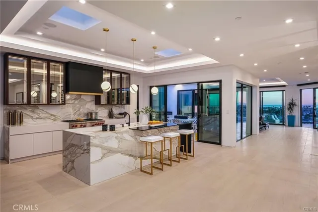 a living room with furniture a floor to ceiling window and an outdoor view