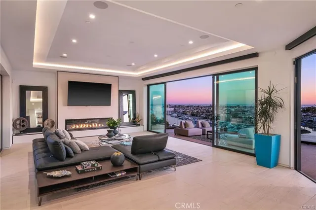 a living room with furniture potted plant and a large window