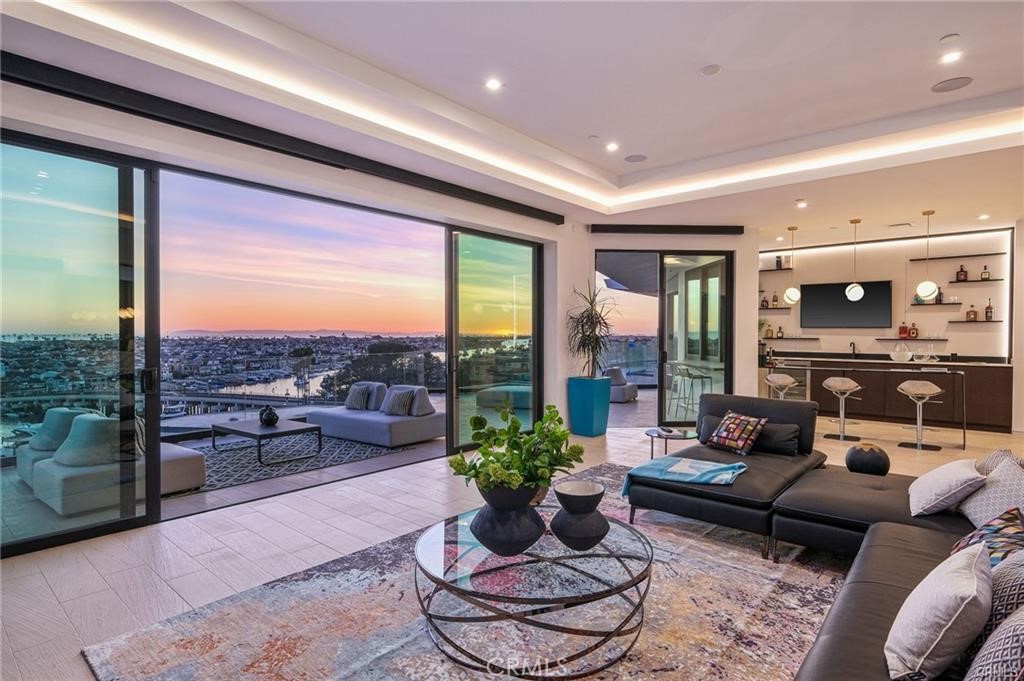 1207 Dolphin Terrace Corona del Mar, CA 92625 - Photo 14 of 58 a living room with furniture potted plant and a large window