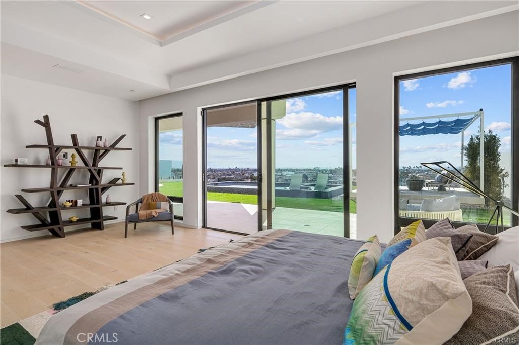 1207 Dolphin Terrace Corona del Mar, CA 92625 - Photo 21 of 58 a living room with couch and a floor to ceiling window