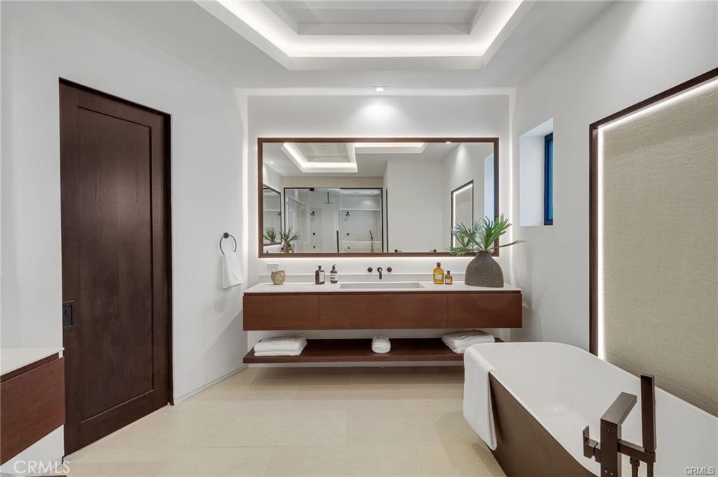 1207 Dolphin Terrace Corona del Mar, CA 92625 - Photo 22 of 58 a bathroom with a bathtub a mirror and a sink