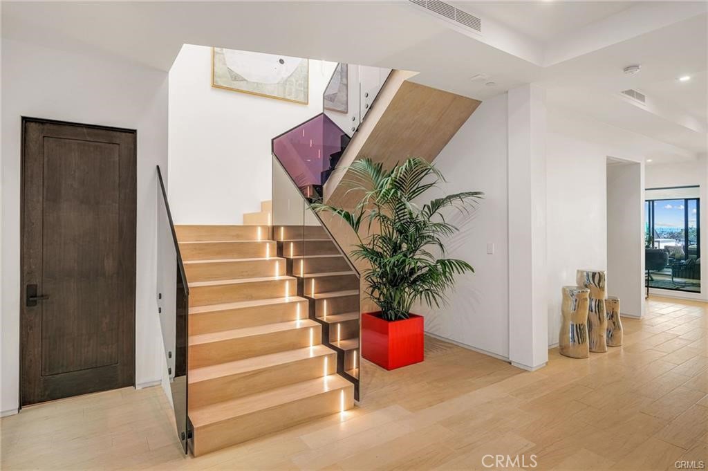 1207 Dolphin Terrace Corona del Mar, CA 92625 - Photo 25 of 58 a view of an entryway with wooden floor and a potted plant