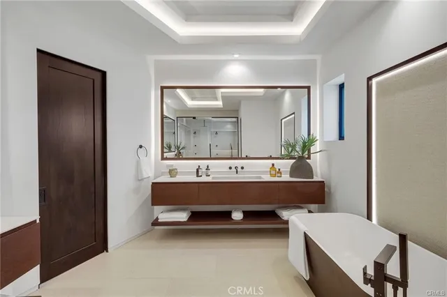 a bathroom with a bathtub a mirror and a sink