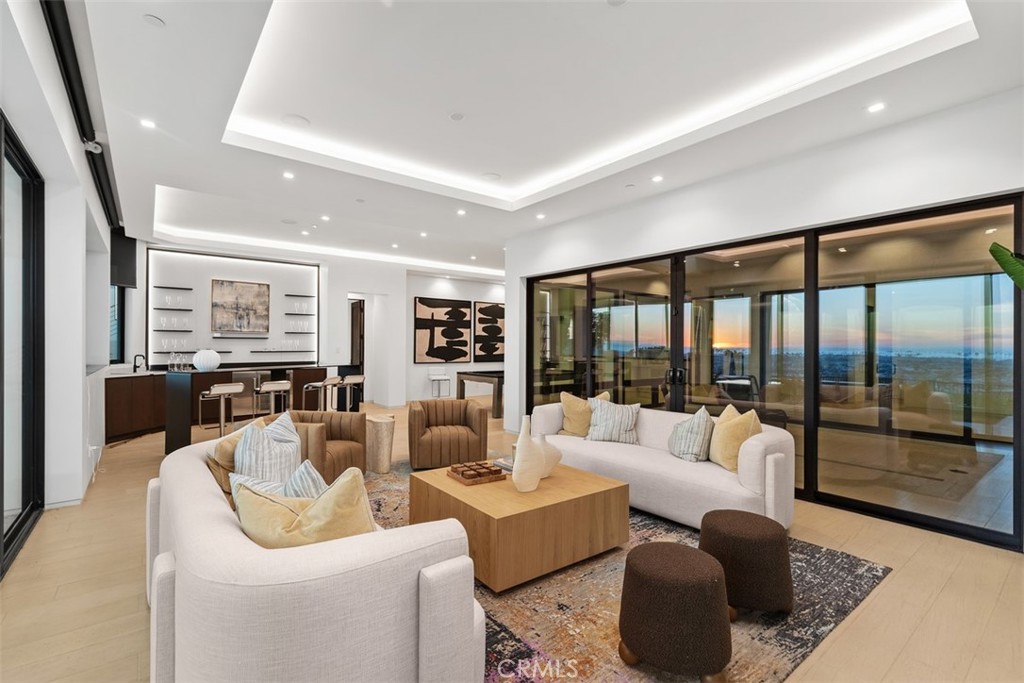 1207 Dolphin Terrace Corona del Mar, CA 92625 - Photo 34 of 58 a living room with furniture and a large window