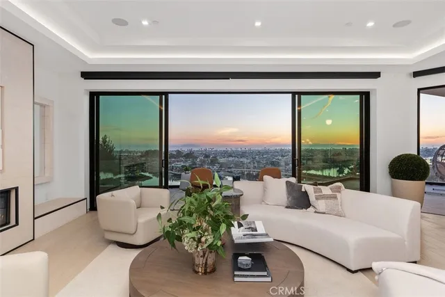 a living room with couches and a large window