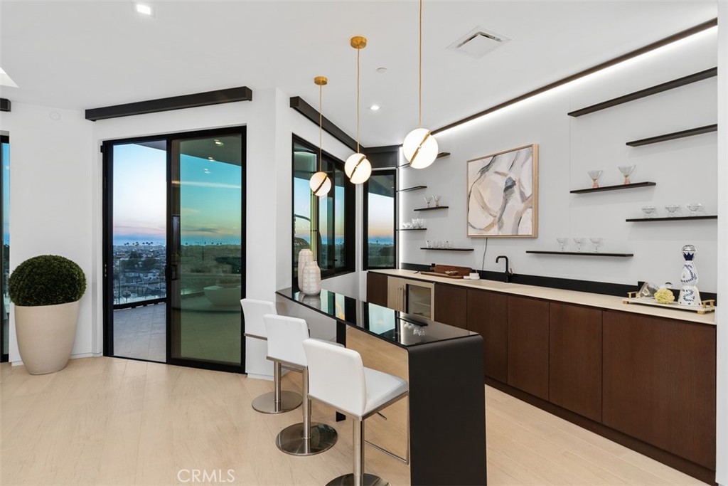 1207 Dolphin Terrace Corona del Mar, CA 92625 - Photo 39 of 58 a kitchen with stainless steel appliances granite countertop a sink and a refrigerator