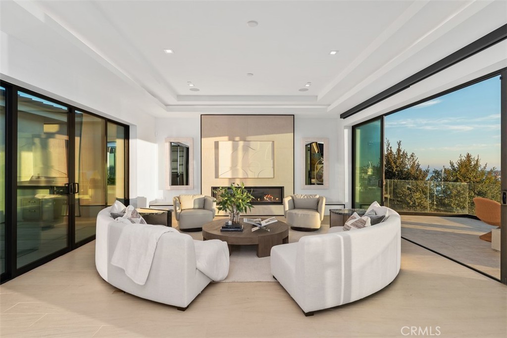 1207 Dolphin Terrace Corona del Mar, CA 92625 - Photo 50 of 58 a living room with fireplace furniture and floor to ceiling window