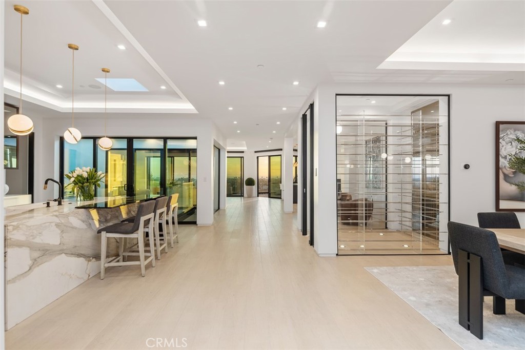 1207 Dolphin Terrace Corona del Mar, CA 92625 - Photo 57 of 58 a dining room with furniture and a floor to ceiling window