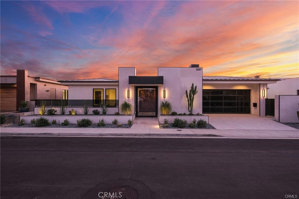 1207 Dolphin Terrace Corona del Mar, CA 92625 - Photo 7 of 58 a front view of a house with a porch