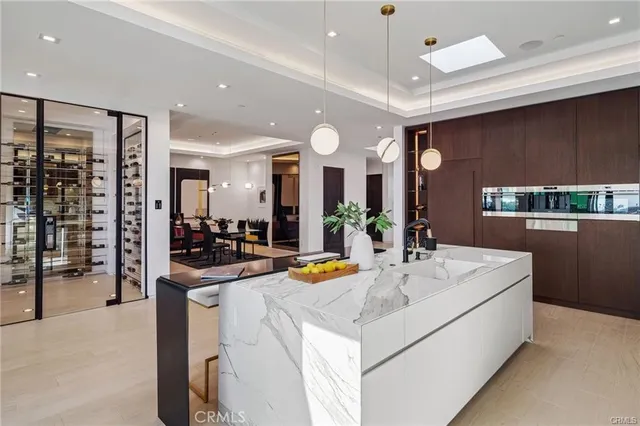 a living room with furniture a flat screen tv and floor to ceiling window