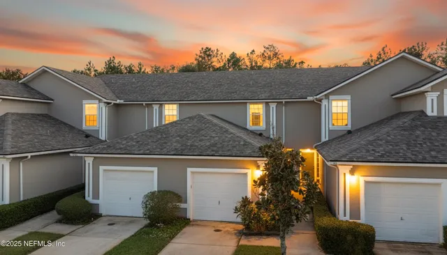 a front view of a house with plants