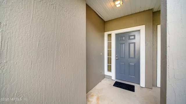 a view of a pathway of house with flower plants