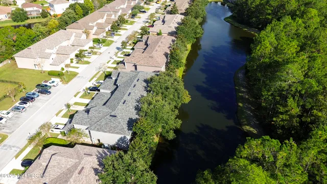 an aerial view of multiple houses with yard