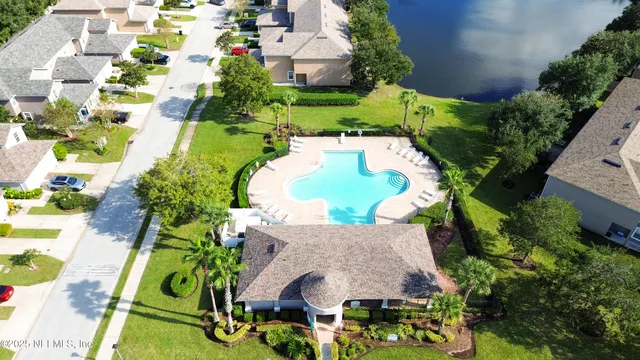 an aerial view of a house with outdoor space and swimming pool