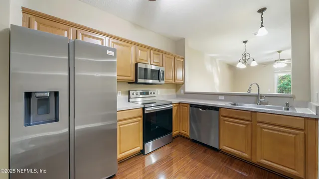 a kitchen with a sink stainless steel appliances and cabinets