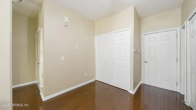 an empty room with wooden floor