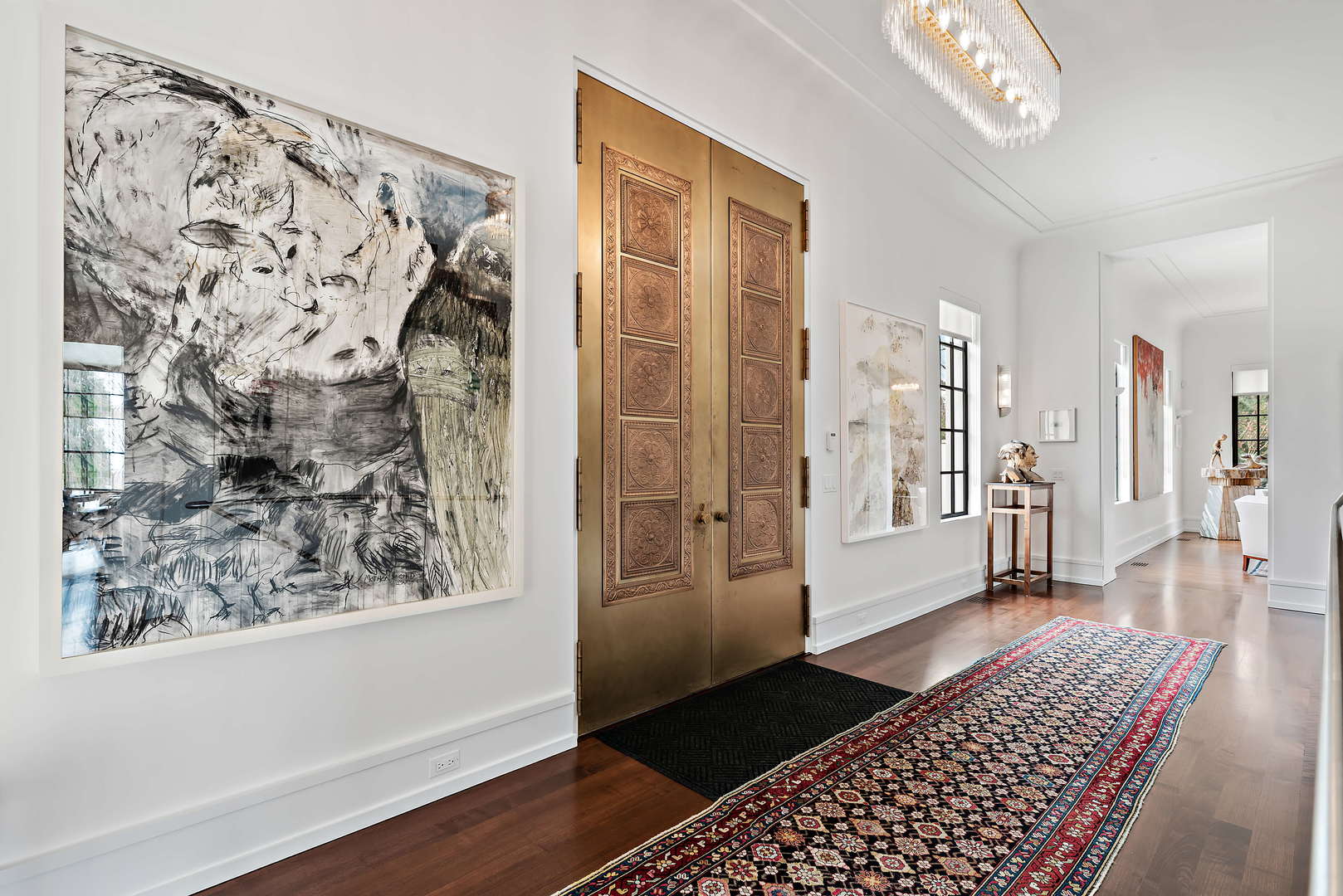 930 Lake Road Lake Forest, IL 60045 - Photo 3 of 51 a view of a hallway with wooden floor and a living room