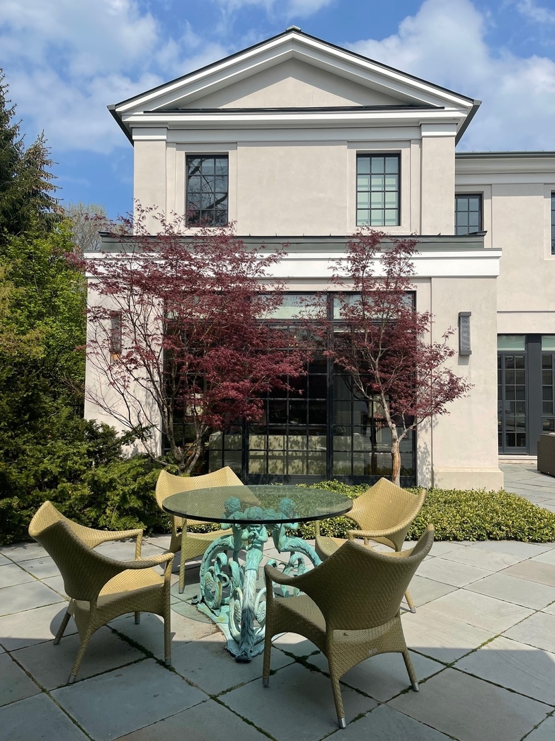 930 Lake Road Lake Forest, IL 60045 - Photo 37 of 51 a front view of a house with a yard glass top table and chairs