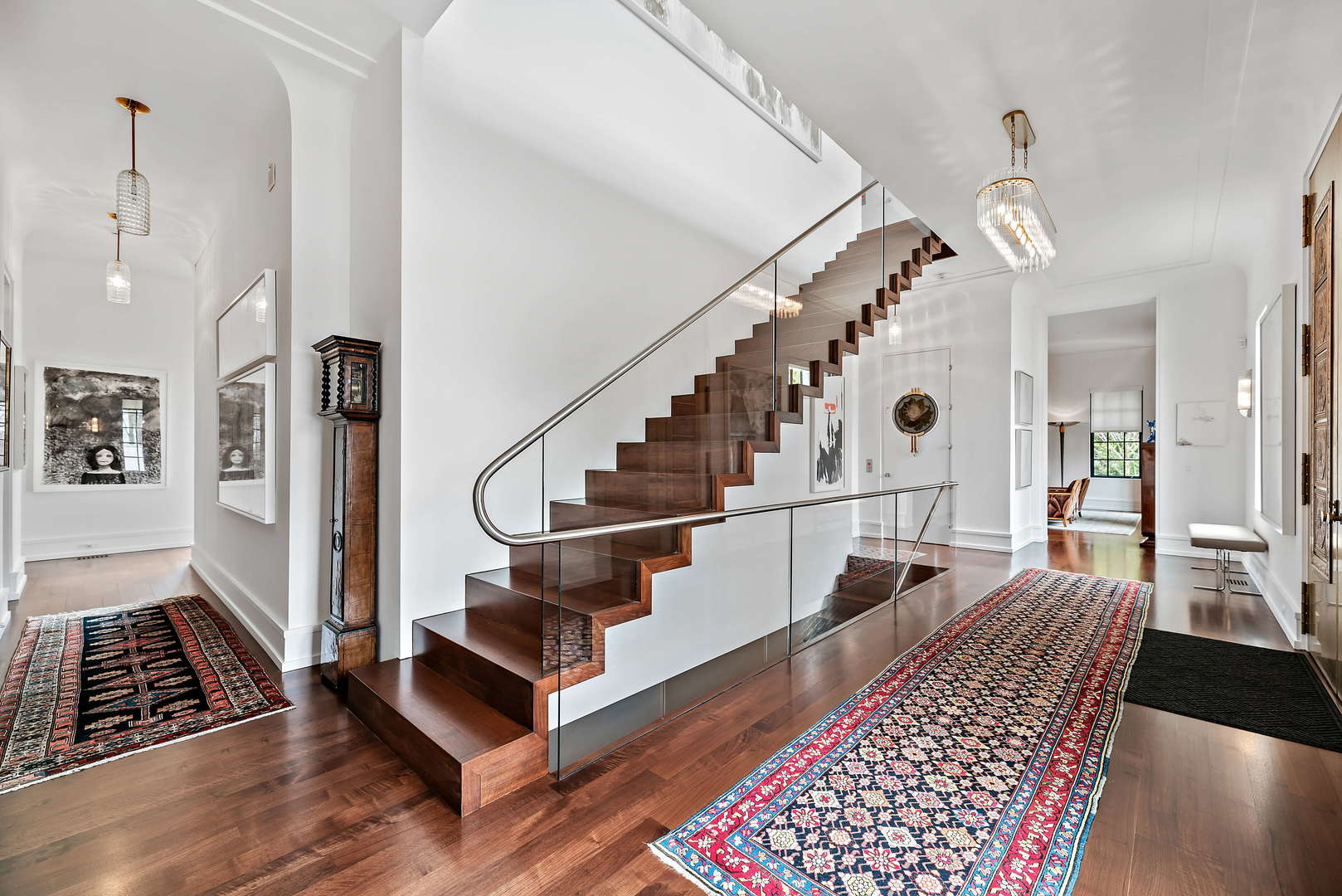 930 Lake Road Lake Forest, IL 60045 - Photo 4 of 51 a view of staircase with lots of frames and a rug