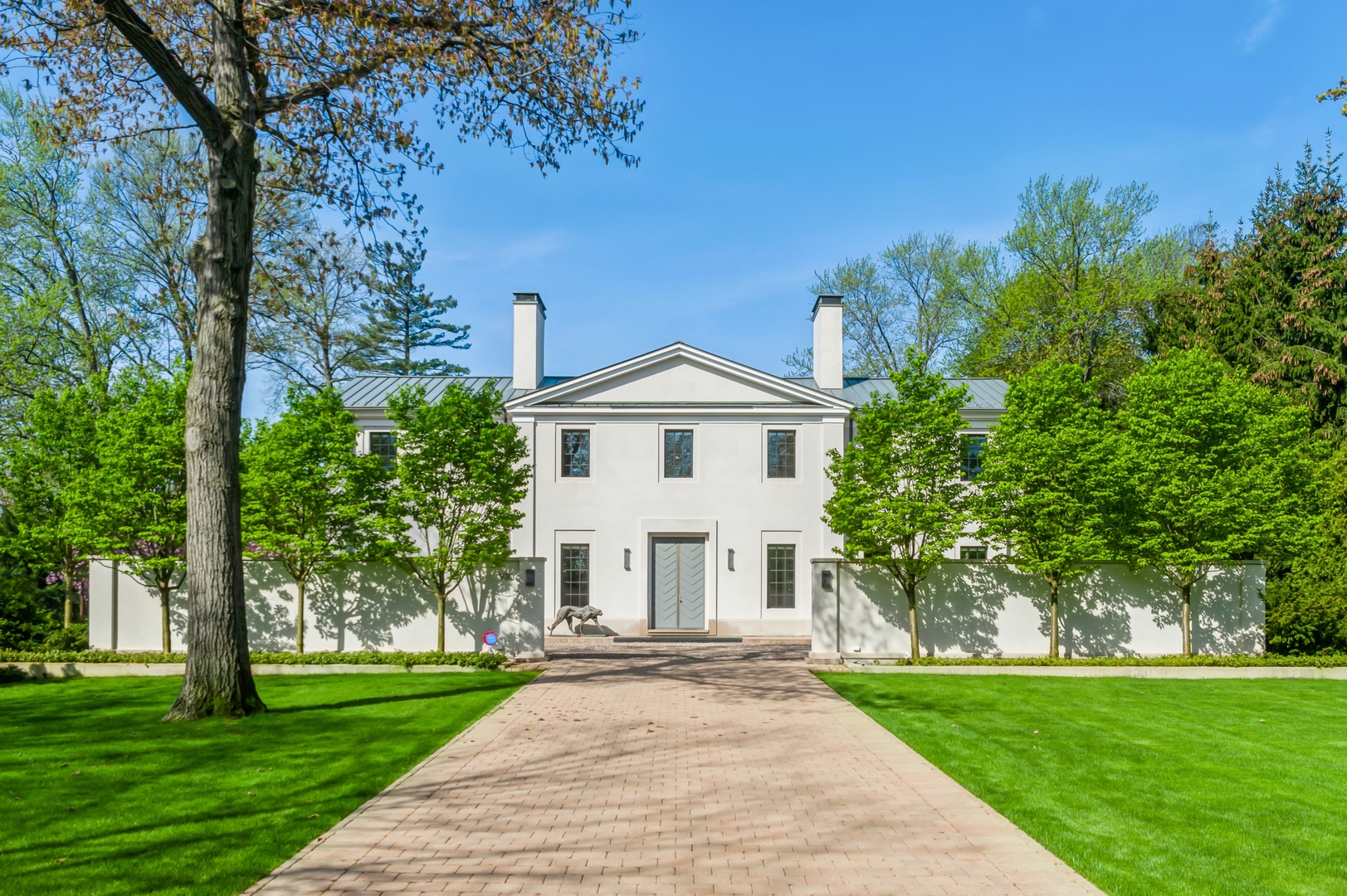 930 Lake Road Lake Forest, IL 60045 - Photo 51 of 51 a view of a white house with a big yard and large trees
