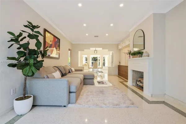 a living room with furniture potted plant and a fireplace