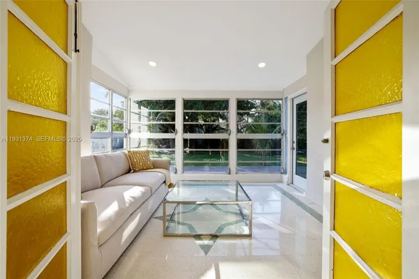 a living room with a blue floor to ceiling windows and a table