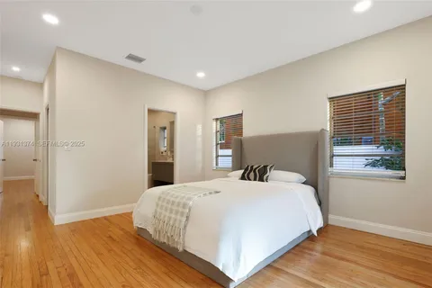 a bedroom with a bed and a painting on the wall