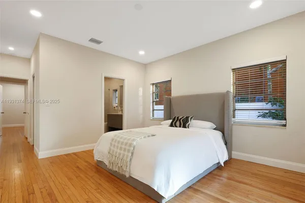 a bedroom with a bed and a painting on the wall