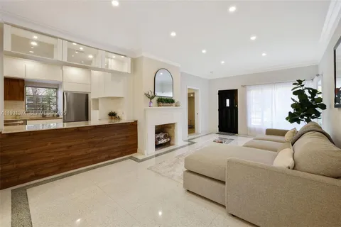 a living room with furniture fireplace and mirror