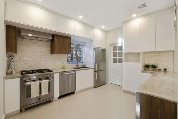 a kitchen with a stove and a refrigerator