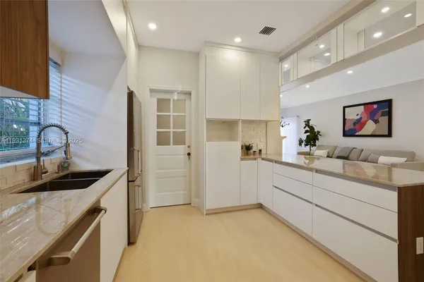 a kitchen that has a sink and a stove in it
