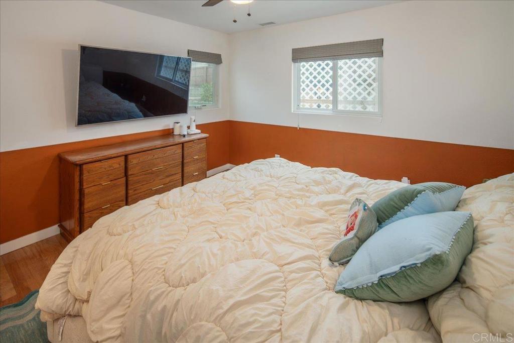 14539 Kennebunk Street Poway, CA 92064 - Photo 17 of 26 a bedroom with a bed and flat screen tv